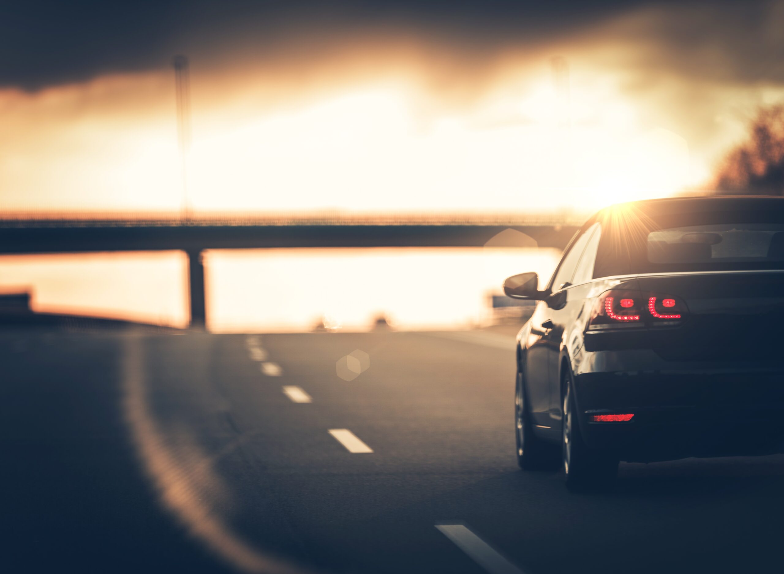 Highway Car Trip. Small Compact Car on the Highway During Sunset.